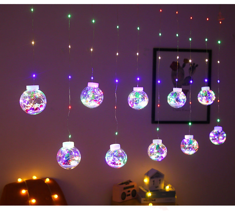 Curtain light with baubles and Christmas figures