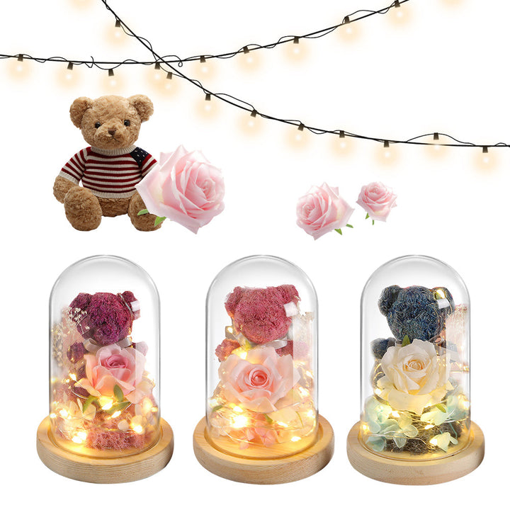 Teddy bear with eternal rose under glass dome with warm LED light