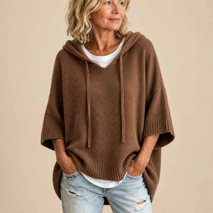 Knitted hooded poncho with three-quarter sleeves