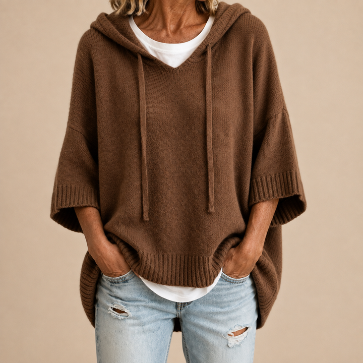 Knitted hooded poncho with three-quarter sleeves
