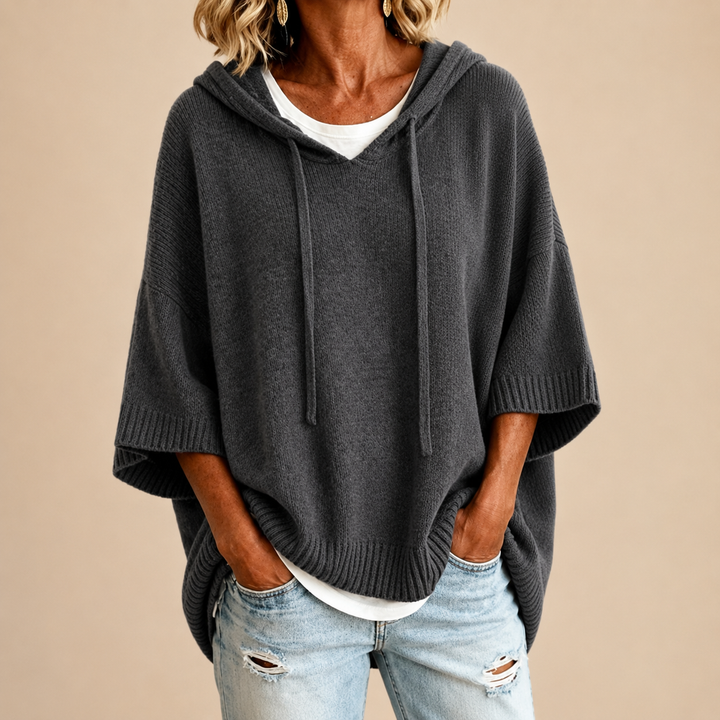 Knitted hooded poncho with three-quarter sleeves