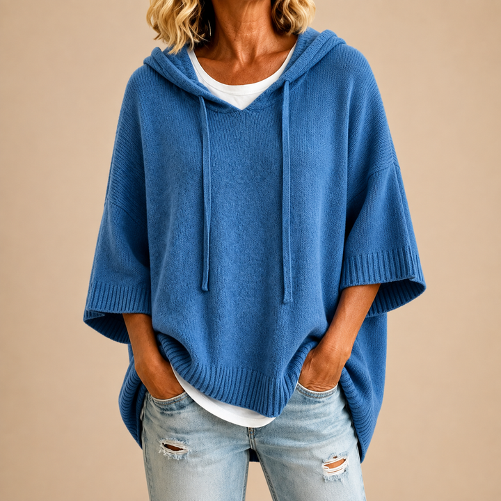 Knitted hooded poncho with three-quarter sleeves
