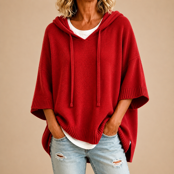 Knitted hooded poncho with three-quarter sleeves