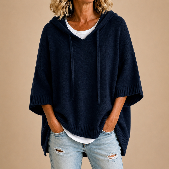 Knitted hooded poncho with three-quarter sleeves