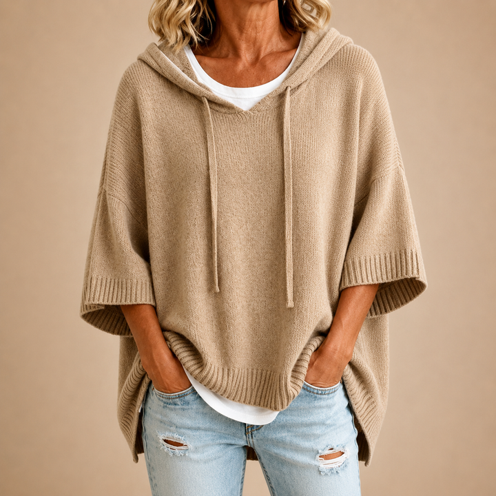 Knitted hooded poncho with three-quarter sleeves
