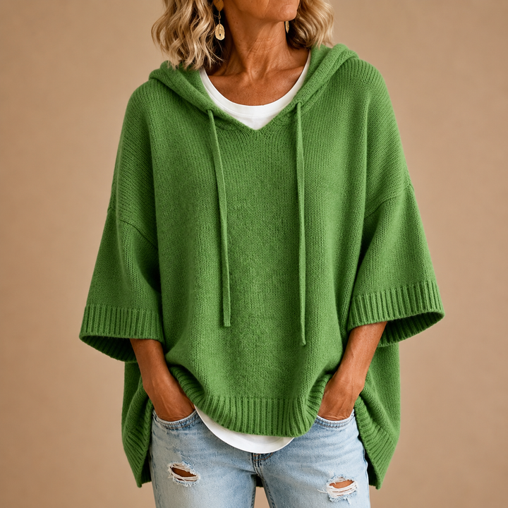 Knitted hooded poncho with three-quarter sleeves