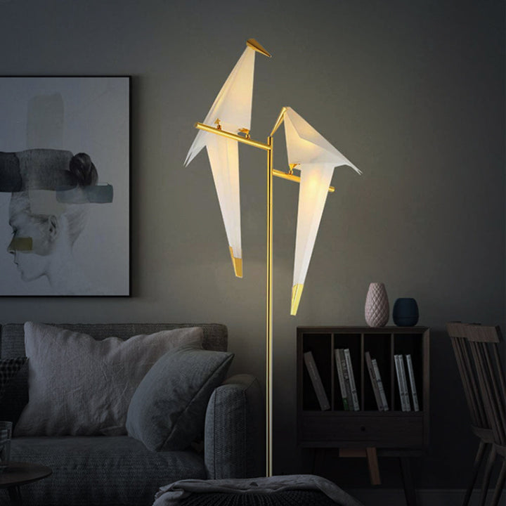 "Elegant wireless origami bird lamp with magnetic attachment emitting warm light; enhances home decor with artistic design."